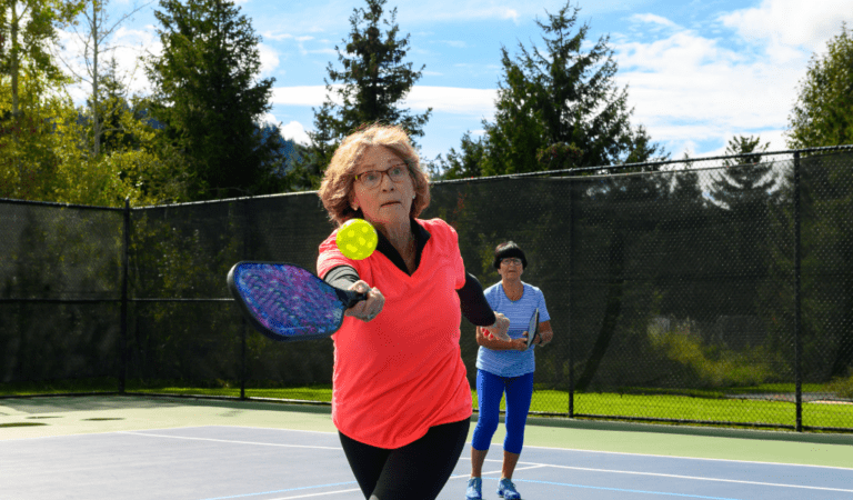 elderly woman playing pickleball