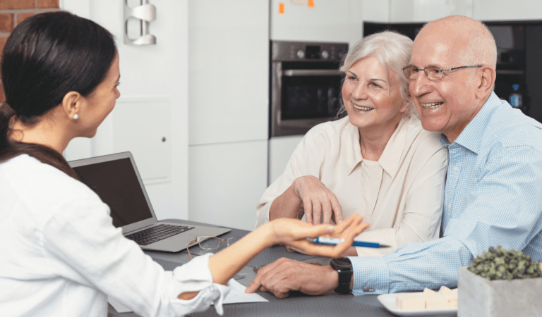 elderly couple talking with a woman