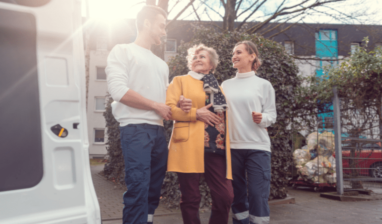 people helping an older woman