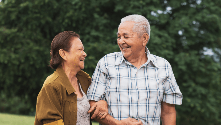 a senior couple walking together and holding hands