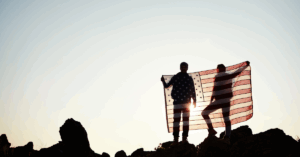 people on a hill with USA flag
